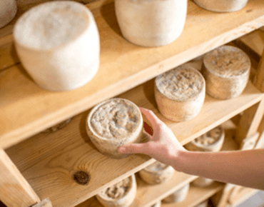 a man carrying a cheese