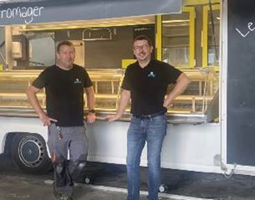 Picture of two workers from Euromag in front of their truck. 