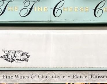 A picture of the storefront of the The fine cheese co shop. 